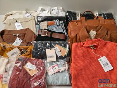 many different types of clothes and bags on the table