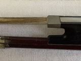 two wooden sticks and a camera on a white cloth