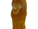 a glass figurine of a horse on a white surface