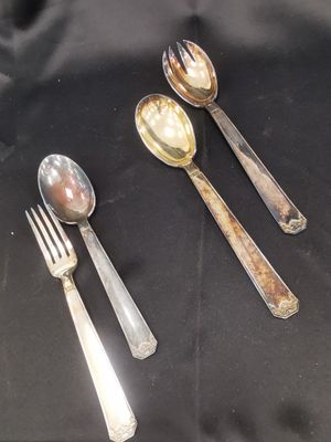 three spoons and two spoons on a table
