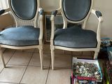 two chairs that are next to each other on the floor