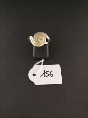 a close up of a ring on a black surface with a price tag