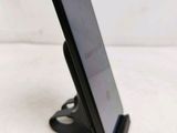 a cell phone that is on a stand on the table