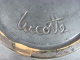 a close up of a silver plate with a name on it