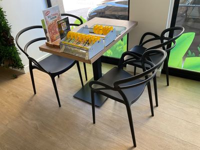 a table with four chairs and a board game on it