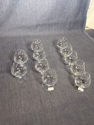several empty wine glasses are lined up on a couch