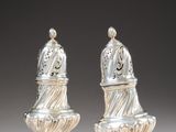 pair of silver salt and pepper shakers on pedestals