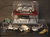 three cars in a display case on a black background