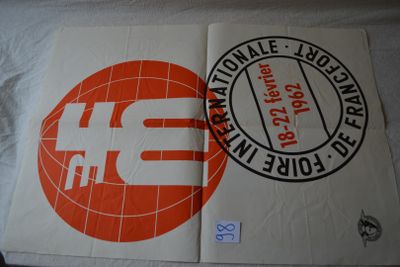 two posters on a bed with a red and white design