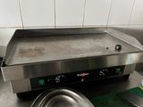 a metal pan sitting on top of a stove in a kitchen