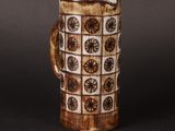 a brown and white mug with a handle on a table