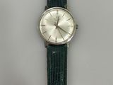a close up of a wrist watch on a white surface