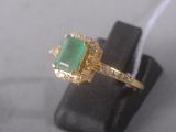 an image of a ring with a green stone
