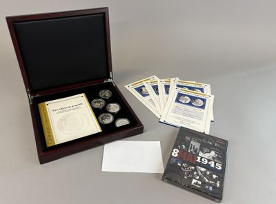 a wooden box with a book and a set of coins