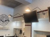 une photo d'une cuisine avec une télévision fixée au-dessus de la cuisinière