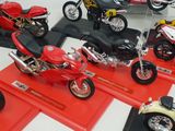 many different types of motorcycles on display in a display case