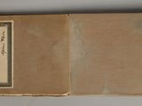 an old book with writing on it sitting on a table