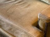 a couch that has a pillow on it in a living room