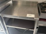 a stainless steel table with a stove in the middle of it