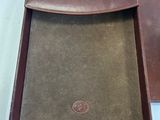 brown leather case for a laptop with a brown leather cover
