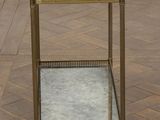 an image of a brass and glass side table on a parquet floor