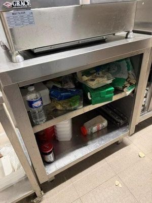 une cuisine en inox équipée d'un évier et d'un plan de travail