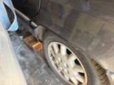 a close up of a car ' s tire with a hose attached to it