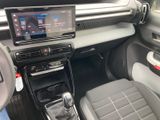 the interior of a car with a touch screen and a steering control