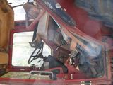 a man sitting in the driver ' s seat of a red truck