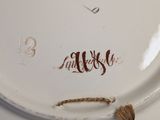 a white plate with a brown design on it
