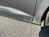 a close up of a black car with a flat tire