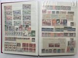 an open book with stamps on it on a table