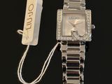an image of a wrist watch with a tag attached to it