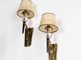 pair of brass sconces with lamps on a white wall
