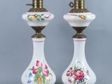 pair of white and gold vase lamps with floral designs on them