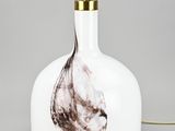 white and brown marbled glass bottle lamp with a gold metal base