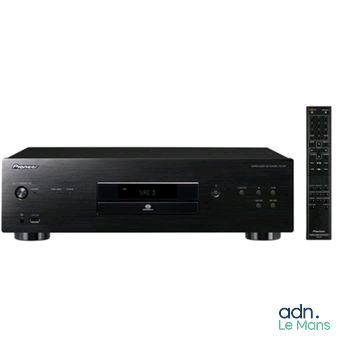 a close up of a cd player with a remote on a white background