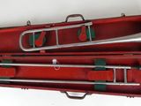 a red case with a silver trumpet inside of it