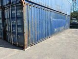 a large blue container sitting in the middle of a parking lot