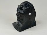 a close up of a sculpture of a man ' s head on a white surface