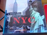 a picture of a book on a table with a picture of a statue of liberty on it