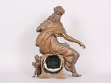 a statue of a man sitting on top of a clock
