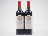 deux bouteilles de vin rouge posées l'une à côté de l'autre sur une surface blanche