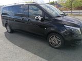 a picture of a black van parked in a parking lot