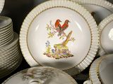 many plates and bowls that have birds on them