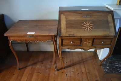 two wooden tables with drawers on them in a room