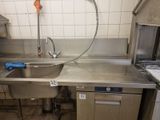 a kitchen with a sink, stove, and dishwasher in it