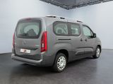 the grey van is parked in a large room with a black floor