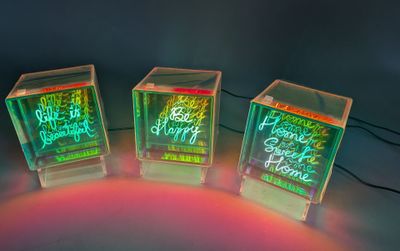 three cubes that have been lit up with neon lights