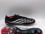 a pair of black and red soccer shoes on a white background